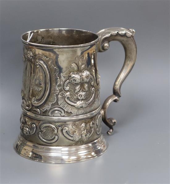 A late George II silver mug, with later embossed decoration, London, 1757 (a.f.), 14.5 oz.